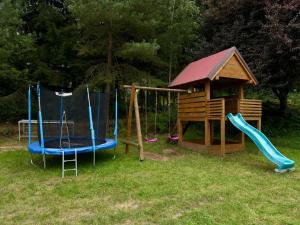 a playground with two swings and a gazebo at Agroturystyka Alex in Szczecinek