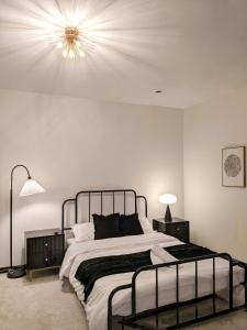 a bedroom with a large bed with a light on the ceiling at Bishop Hostel in Dallas