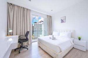 a white bedroom with a desk and a bed and a window at One Bukit Ceylon OSuites in Kuala Lumpur +4 photos