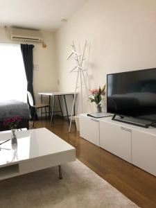 a living room with a large flat screen tv at Apartment in Narita 110 in Narita