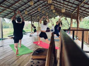 a group of people in a yoga class at Roys Villa Sigiriya in Sigiriya