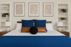 a bedroom with blue and orange pillows on a bed at Summer Splash Pool, Spa & Game Room in Mesa +72 photos
