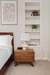 a bedroom with a bed and a table with a lamp at Summer Splash Pool, Spa & Game Room in Mesa