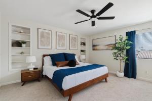 a bedroom with a bed and a ceiling fan at Summer Splash Pool, Spa & Game Room in Mesa
