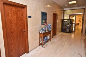 a hallway of a pharmacy with a door and a counter at Hotel Adsubia in Denia