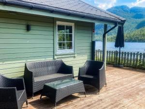 a house with chairs and a table on a deck at 8 person holiday home in jørpeland-By Traum in Jørpeland