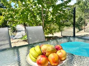 a plate of apples and bananas on a table at Home in the Hills in Ayios Ioannis