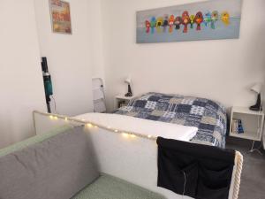 a bedroom with a bed and a string of lights at Studio "La fleur de Lys" in Ault