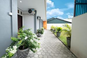 a courtyard of a house with potted plants at ARGA SHANKARA House in Sempidi