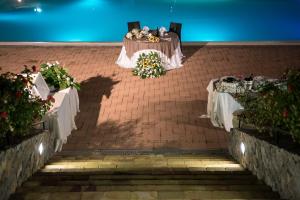 a wedding table with a shadow of a person at Valle Himara in Piana degli Albanesi +48 photos