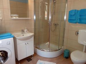 a bathroom with a shower and a sink and a toilet at Apartments Tamaris in Trogir