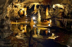 a large cave with lights in the cave at Malinovy Sen in Habovka
