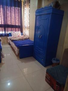 a blue cabinet and a bed in a room at Sun City in Aswan