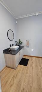 a bathroom with a sink and a mirror in a room at Namaqua Bella Vista in Springbok