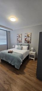 a bedroom with a large white bed in a room at Namaqua Bella Vista in Springbok