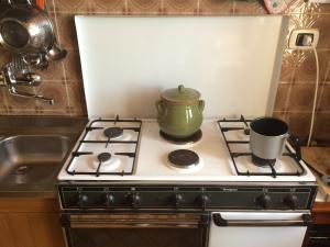 a stove top with a pot on top of it at Dreams House in Agerola