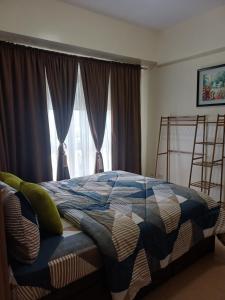 a bedroom with a bed in front of a window at Pasay 1BR Family Staycation with Parking in 150 Newport Boulevard near Resort World & NAIA T3 in Manila