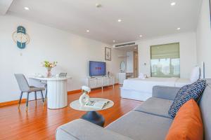 a living room with a bed and a couch at La Casa Nha Trang - GoldCoast Tower, Yellow-Amber-Beach & Lotte Mall in Nha Trang