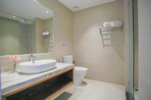 a bathroom with a sink and a toilet and a mirror at La Casa Nha Trang - GoldCoast Tower, Yellow-Amber-Beach & Lotte Mall in Nha Trang +57 photos