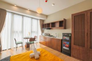 a bedroom with a kitchen and a dining room at Vừng Hotel in Hue