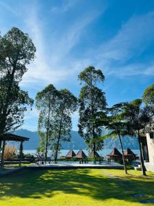 a park with trees and buildings in the distance at Segara Healing Bali Glamping With Hot Spring in Kubupenlokan