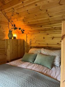 a bedroom with a bed with a wooden wall at Bed & Breakfast Voor De Wind in Slootdorp