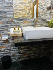 a bathroom with a white sink and a mirror at The Aurelian Ella in Ella