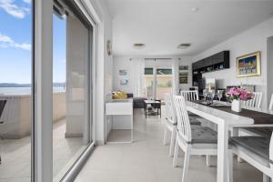 a kitchen and dining room with a table and chairs at House , Seafront Apartment Pelegrin in Stomorska