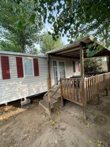 a white house with a porch and a deck at Bungalow 6 à 8 personnes Valras Plage in Sérignan