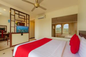 a bedroom with a large bed with red pillows at Praha Hotel Phú Quốc in Phú Quốc +135 photos