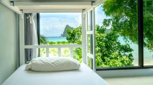a bed in a room with a view of the ocean at Ibiza House Phi Phi in Phi Phi Don +172 photos