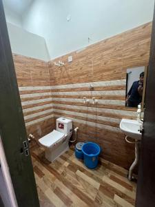 a bathroom with a toilet and a sink and a mirror at Bajrang seva dham in Mathura