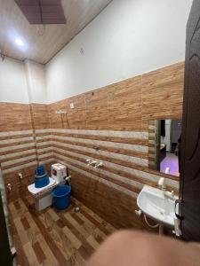 a bathroom with a sink and a toilet and a mirror at Bajrang seva dham in Mathura
