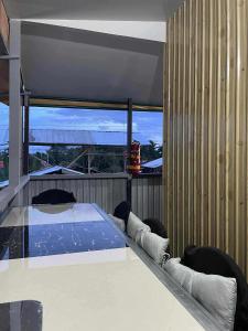 a bedroom with a bed on a balcony at Freundliche Kammer Transient House in Dahikan +34 photos