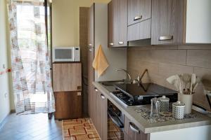 a kitchen with a sink and a stove at Casa Di Amelia in Pompei