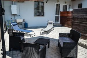 a group of chairs and tables on a patio at Casa Di Amelia in Pompei