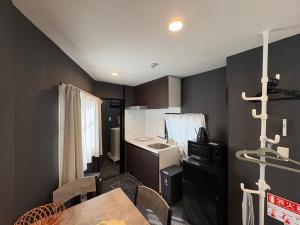 a kitchen with a table and a dining room at Oji正和ビル in Tokyo