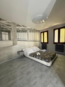 a bedroom with a large bed in a room with windows at City Star in Rovigo