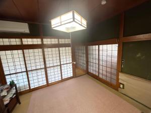 a large room with large windows and a chandelier at Honjo no Ie in Yurihonjo