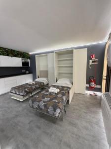 a room with three beds in it at City Star in Rovigo