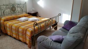 a bedroom with a bed with two pillows and two chairs at B&B RoMa Atella in Atella