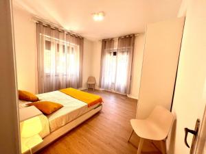 a bedroom with a bed and a chair in it at Villa Anna Francavilla al Mare in Francavilla al Mare