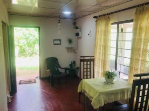 a living room with two tables and a window at House in Koggala in Koggala