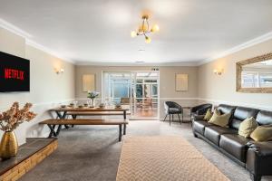 a living room with a couch and a table at Large House New Haven - East Sussex - Sleeps 10 People - Contractors - Families - Discounts for Long Term Bookings! in Newhaven