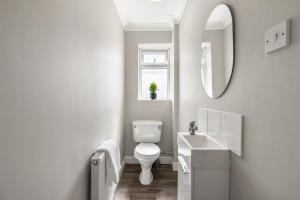 a white bathroom with a toilet and a sink at Large House New Haven - East Sussex - Sleeps 10 People - Contractors - Families - Discounts for Long Term Bookings! in Newhaven +35 photos