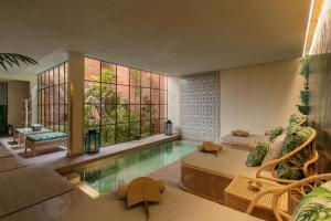 a living room with a swimming pool in a house at Riad Kheirredine in Marrakesh