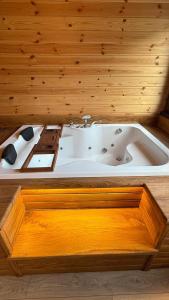 a bath tub in a room with a wooden wall at بيوت رفال Refal Homes in Ardeşen +13 photos