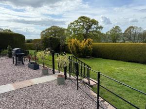 a garden with a black fence and a lawn at Garden cottage at The Glebe in Bayton