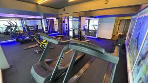 a gym with treadmills and elliptical machines at Castelmar Hotel in Florianópolis