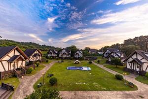 an aerial view of a village with houses at Jeju Mungmung Place Dog Pension in Jeju